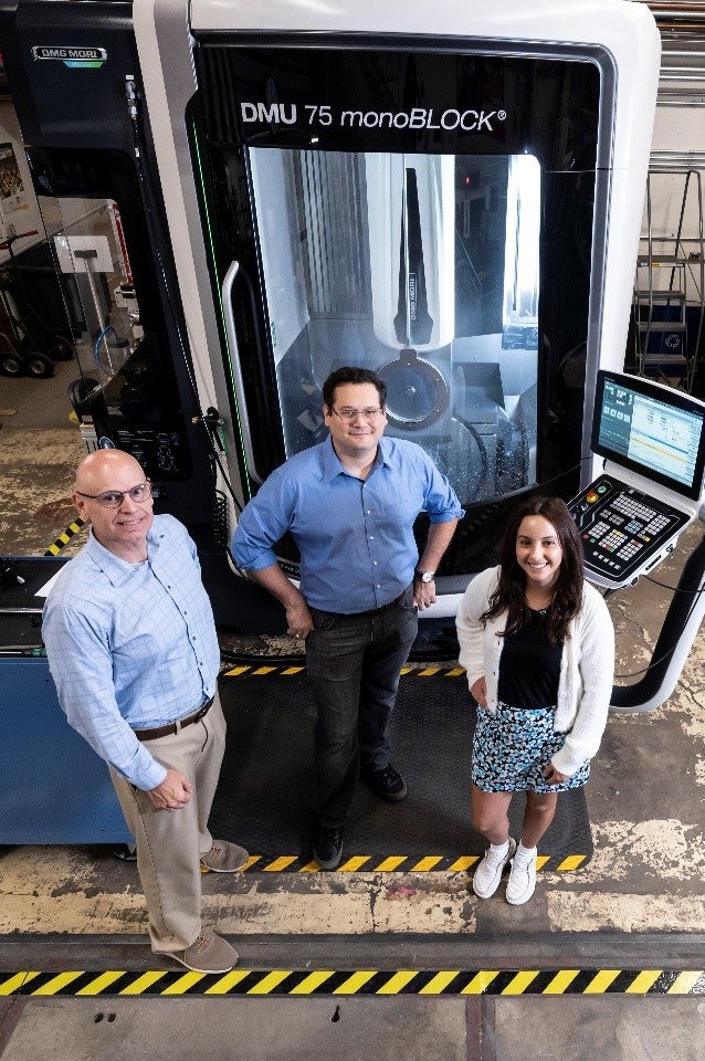 researchers in front of precision milling machine