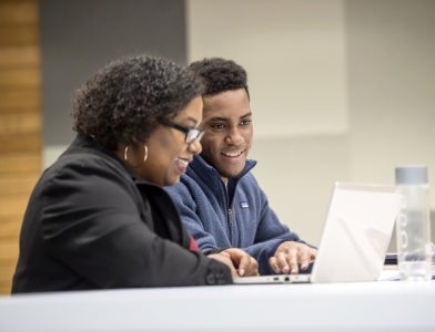 Pitt employees communicate via laptop computer.